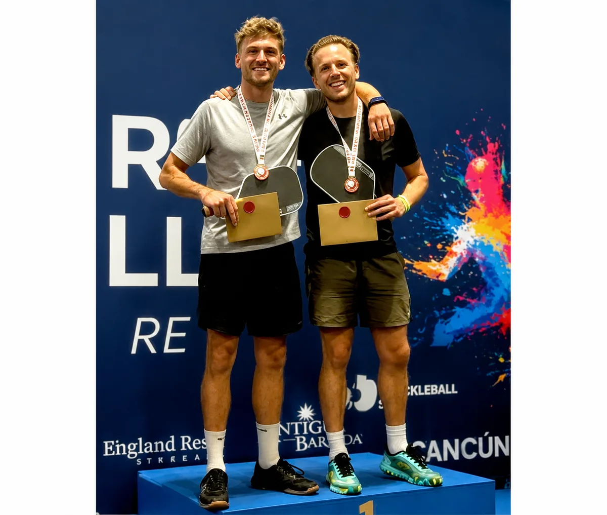 Mark Timms, right, and his doubles partner on the top step of the podium at the 2026 English Open