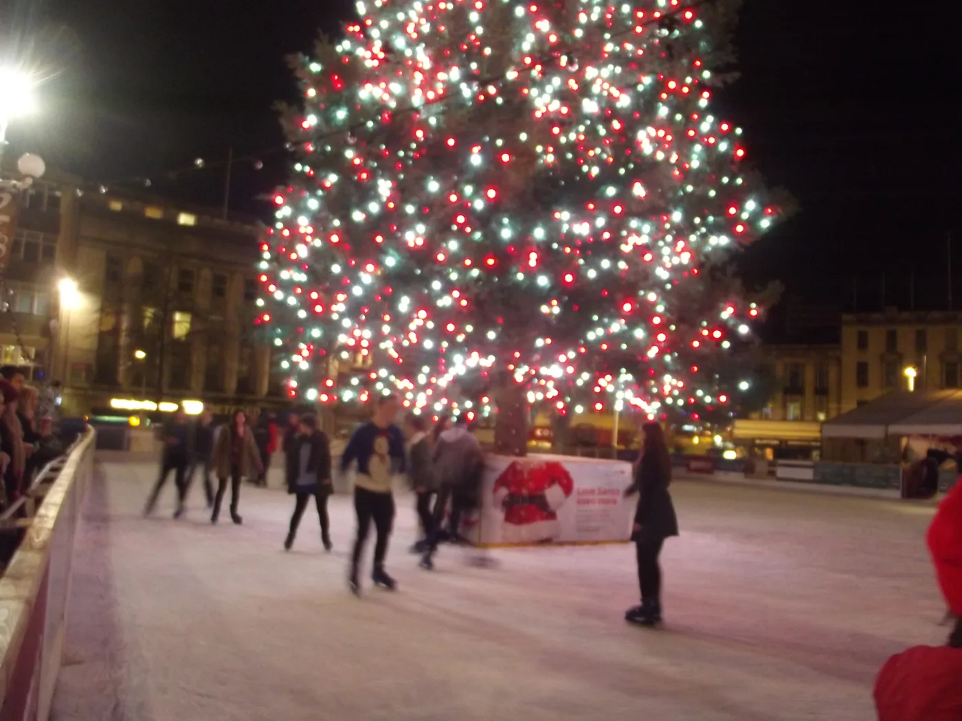 Skaters on the Winter Wonderland ice rink beside the Christmas tree in Old Market Square, Nottingham